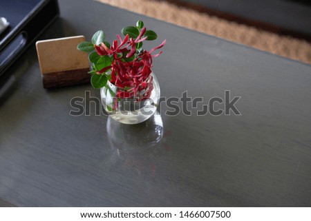 Mock up label stand with flower water vase on table in room for welcome reception concept