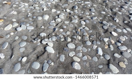 Pebbles on Black Sand Beach New Zealand