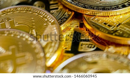 Golden Bitcoins. New virtual money. Macro shot of top view pile of many Gold Bitcoin coins. Cryptocurrency trading concept.