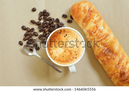 Top view of a cup of fresh coffee,espresso and  bread on the brown paper floor