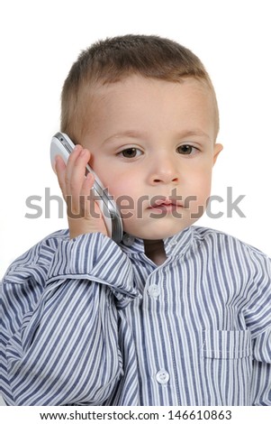 Little boy with cell phone on white background
