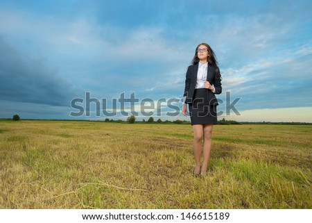 Young and beauty business woman on green field