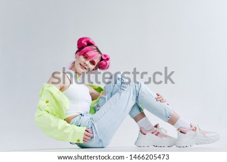 woman with pink hair sitting on the floor