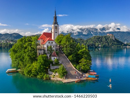 Bled, Slovenia - Aerial drone view of beautiful Lake Bled (Blejsko Jezero) with the Pilgrimage Church of the Assumption of Maria and Bled Castle and Julian Alps at backgroud on a bright summer day Royalty-Free Stock Photo #1466220503