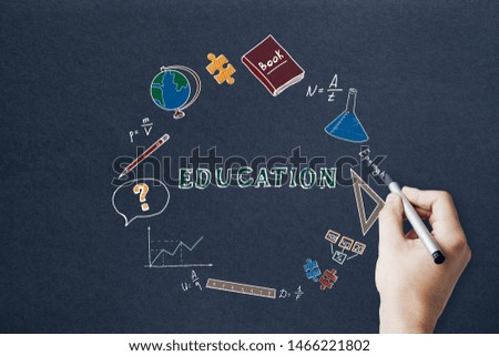 Knowledge and science concept. Creative hand drawn educational sketch on dark paper background