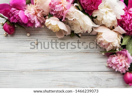 Background with pink peonies on white wooden   board