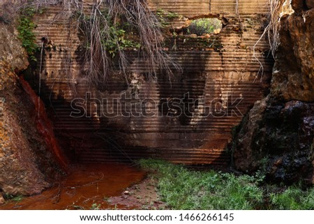 An old dam wall collecting and leaking water in a kloof in South Africa. 