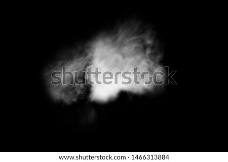 Freeze motion of white dust explosion on black background. Stopping the movement of white powder on dark background.
 Explosive powder white on black background.
