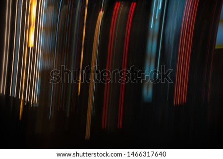 Lights and stripes moving fast over dark background.