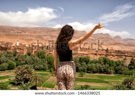 An Image of Beautiful Landscape in Morocco. A Girl Waving with Hand.