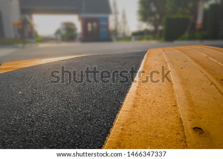 Washboard road on asphalt surface painted with different color of black and dark yellow speed bump or speed breaker 