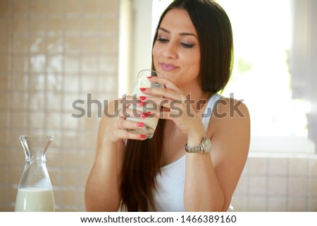 Young woman drinking milk from cup stock photo