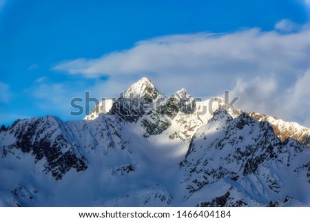 Panoramically view over Austrian Alps peaks covered with snow.