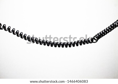 black vintage spring cable (wire) on white background verticaly 