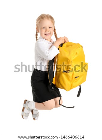 Portrait of jumping little schoolgirl on white background