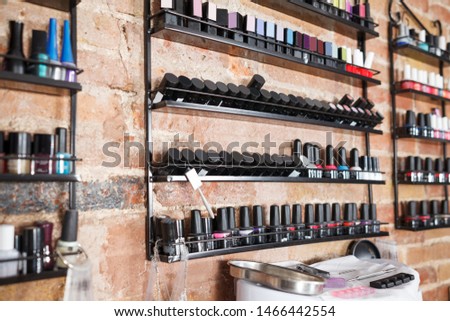 Picture of work place with modern nail polishes and equipment in nail salon
