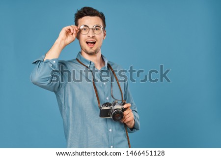 Handsome man blue background lifestyle photo camera