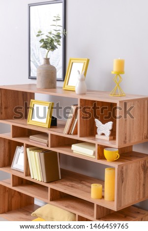 Wooden rack with stylish decor in room
