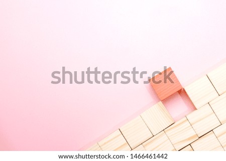 Wooden block toy over pink background