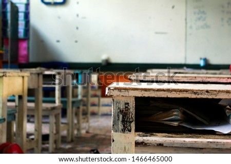 
old school desk with other desks and white board on background in classroom , at the rural school development education concept. 
