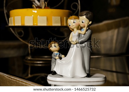 wedding cake with dolls as bride and groom
