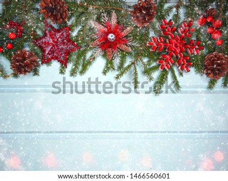 winter christmas background with decor on fir branches cones and snow on blue wooden texture                              
