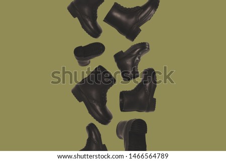 dark brown boots flying in the air Royalty-Free Stock Photo #1466564789