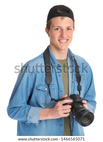 Teenage boy with photo camera on white background