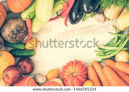Healthy food background with autumnal vegetables and fruits. Autumn fruits vegetables and leaves. Thanksgiving day concept. Top view. Copy space