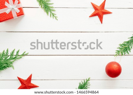 Christmas composition. Frame made of Christmas decorations, red balls. stars, fir tree branches on wooden white background. Christmas, New Year, winter holiday concept. Flat lay, top view, copy space