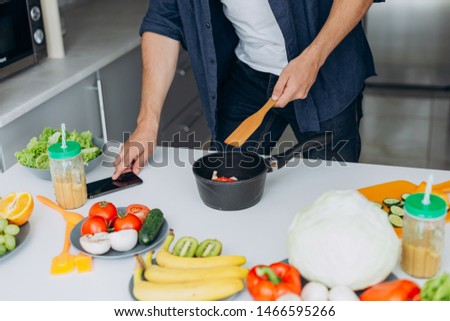 Cropping image a male hands during preparing a vegetable and touches a phone