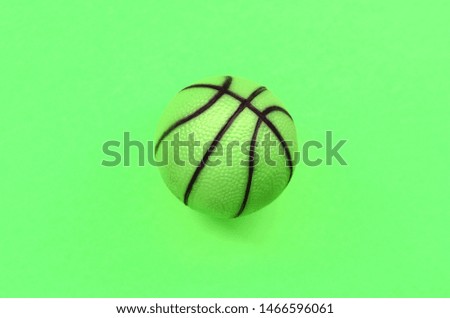 Small green ball for basketball sport game lies on texture background