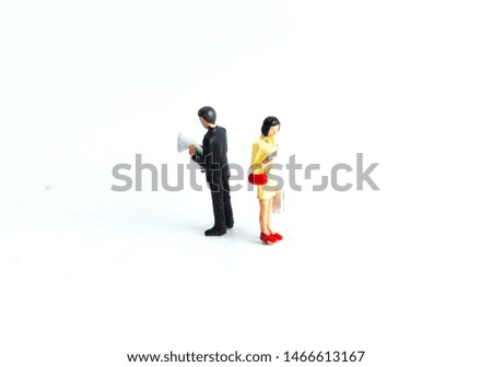 Miniature People Looking at Media/Newspaper/Phone Standing on a White Isolated Background