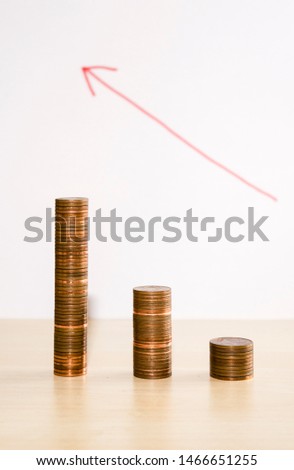 stacked coins of 1, 2 and 5 cents in piles of 50 cents - more coins, less value - devaluation of currency