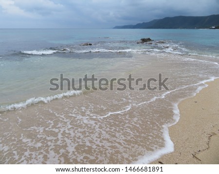 Sandy beach waves at Tebiro Beach in Amami Oshima in Kagoshima
