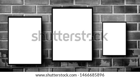 black and White frames on brick wall