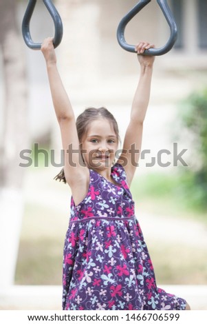 Little girl on the playground in the park