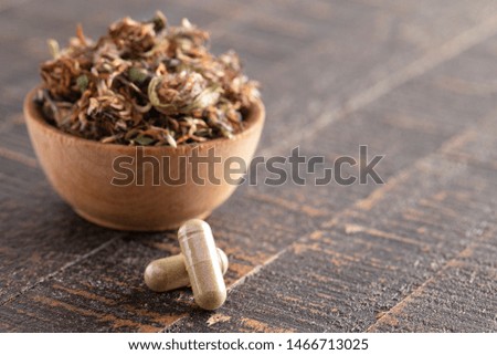 Dried Red Clover Flowers and Leaves on a Rustic Wooden Table