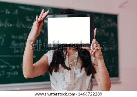 Woman holding a blank screen white mockup. Image