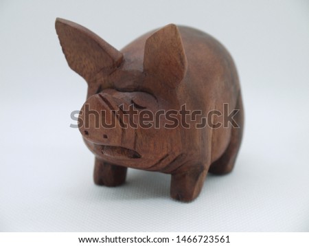 Wooden pig on white background
