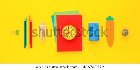 Back to school concept. School objects on yellow background. 