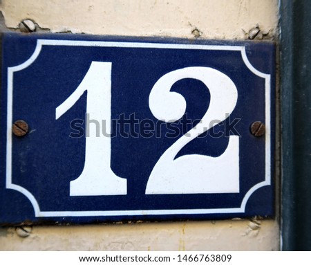 Number 12, street number plate on a facade.