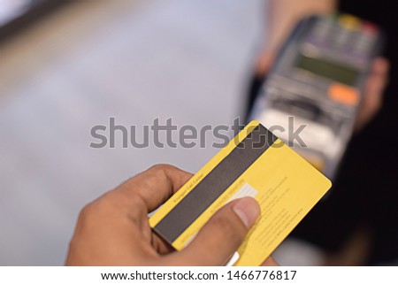 Close-up shots of men holding credit cards