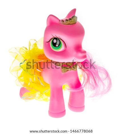 Pink rubber pony with big eyes in a skirt an diadem - toy for little girls