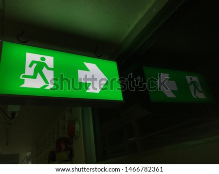 Fire exit signs and reflections in the mirror