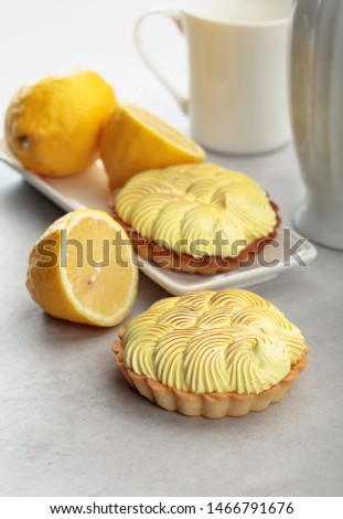 Tartlets with lemon cream on a white marble table. 
