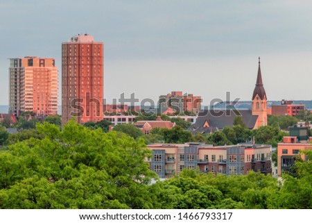 A Close Up Cityscape Shot of Milwaukee High Rises and Unique Church during a Summer Sunset