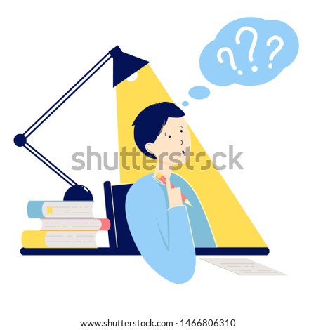 Schoolboy or student sitting at a desk with books. Boy thinks and answers exam questions. 