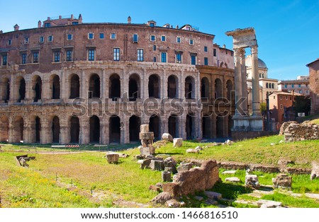 View of many stones and ruins before Temple of Apollo Medicus Sosianus and Teatro Marcello in old town of Rome, Italy. Warm sunny day in autumn.