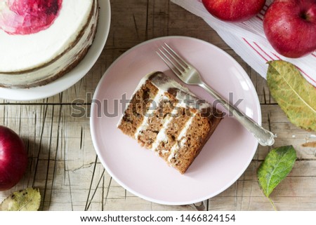 Apple cake with curd cream, decorated with painted apple on the background of autumn composition. Rustic style.